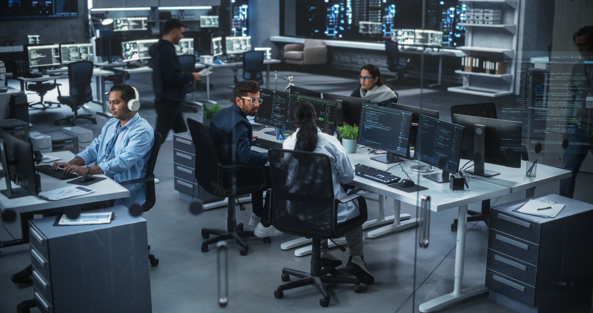 Team of Talented Young Indian Professionals Working in a Technological Research and Development Agency in South Asia. Computer Screens with Software Code and Artificial Intelligence Projects